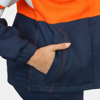 Detalle de bolsillo lateral de chaqueta ignífuga FIREWEAR® bicolor naranjo y azul para mujer.